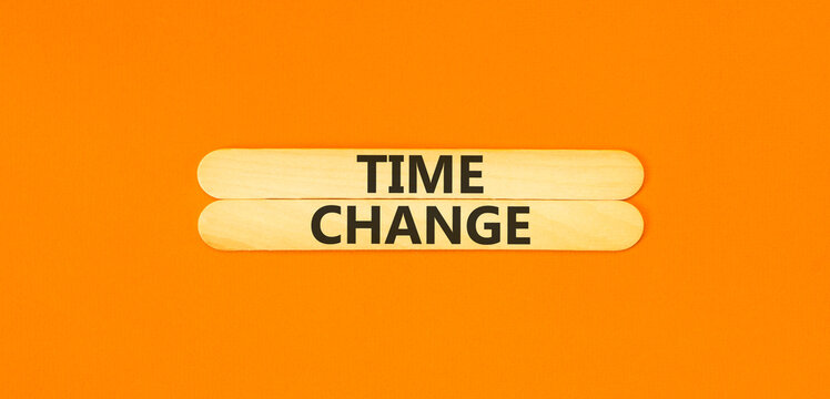 Time change symbol. Concept word Time change on beautiful wooden sticks. Beautiful orange paper background. Business time change concept. Copy space. - Powered by Adobe