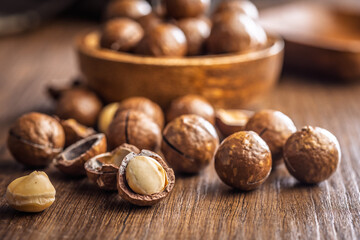Tasty macadamia nuts on wooden table.