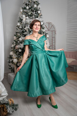 Woman in Green Dress Posing by Christmas Tree