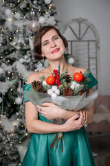 Woman Holding Festive Bouquet by Christmas Tree