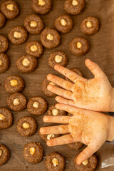 Close up of child's messy palms covered in dough and spices after baking. Fun and authentic Christmas lifestyle shot