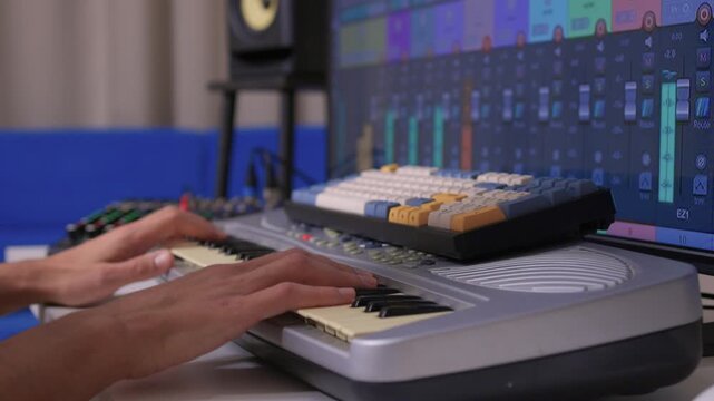 Music producer manipulates faders and displays in dimly lit home studio, Creative audio engineer calibrates channel strips and meters during detailed mixing session