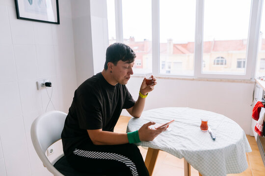 Person actively organizing health routines with medication and tools
