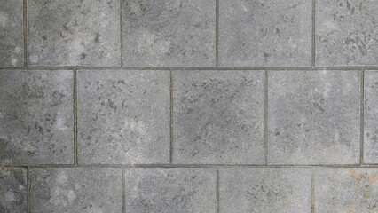 Precast concrete square floor tiles with texture and traction background. Durable gray non-slip paving slabs for sidewalk, patio or walkway. Long-lasting material for outdoor pedestrian traffic area. 