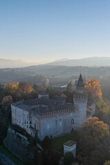 Vertical aerial view of castle and surrounding countryside at sunset along the Trebbia River, Piacenza, Emilia-Romagna, Italy