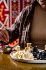 Woman serving traditional Georgian khinkali dumplings