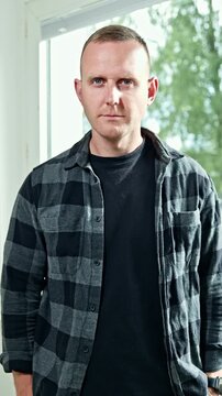 Emotional grimaces on a man's face close-up. A man looks grimly into the camera. A man's face with an angry expression on it. A man looks disdainfully in front of him.