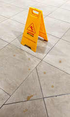 Yellow wet floor warning sign
Dirty floor
