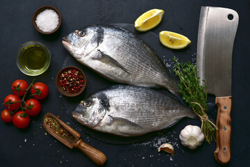 Raw organic dorado with ingredients for making . Top view with copy space.