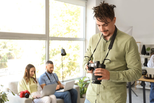 Male photographer with camera during courses in studio