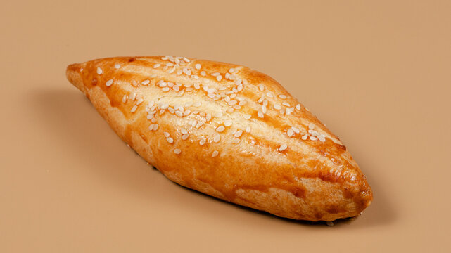 Pirozhki on beige background isolated