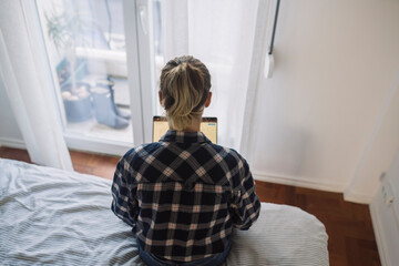 Female relaxing at home with cozy attire and tranquil scene