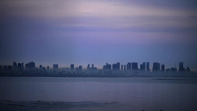 Vibrant of colorful city skyline of the developing urban financial district, modern skyscrapers or high-rise buildings during sunset in the evening, by the coast of the Arabian Sea, Mumbai, India