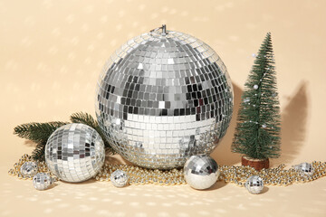 Disco balls with Christmas decor on beige background