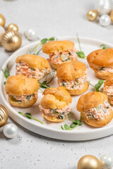 Smoked Salmon Cream Puffs served on a round plate with festive decorations