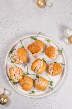 Smoked Salmon Cream Puffs served on a round plate with festive decorations