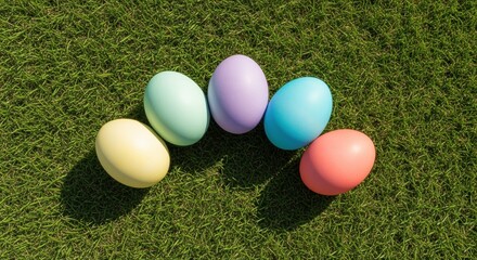 colorful easter eggs arranged on vibrant green grass in sunlight for festive spring celebration