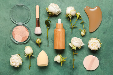 Composition with white rose flowers, powder and bottle of cosmetic product on green grunge background