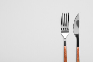 Silver fork and knife on grey background