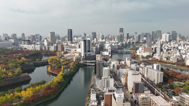 Osaka City CBD, Japan: 4K Drone Footage of Autumn Colours in Central Wards of Kita, Chuo, Miyakojima with Skylines along O and Neya River, Parks and Urban Landscape near Osaka Castle