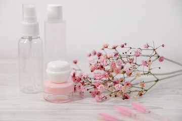 Beauty products with elegant floral arrangement, showcasing skincare essentials and aesthetic appeal