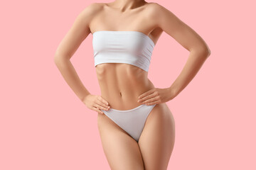 Young woman in underwear on pink background. Liposuction concept