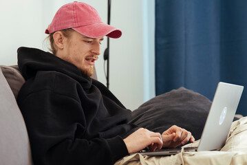 Person in casual attire celebrates success in cozy home setting