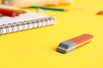School eraser on yellow background