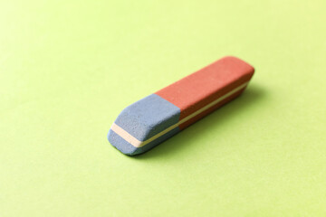 School eraser on green background