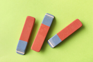 School erasers on green background
