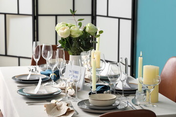 Elegant table setting for Nobel prize day with flowers and candles in dining room