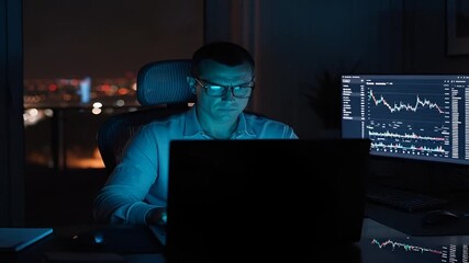 Man analyzing stock market data late at night for investment strategy and financial growth plan - Powered by Adobe