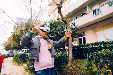 Adult wearing VR gear performing energetic dance amidst city surroundings