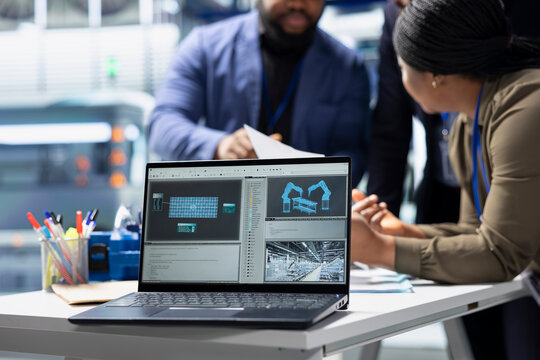 Group of professional consultants reviewing data and checklists in a high tech solar panel plant, ensuring manufacturing process meets sustainable energy and innovation standards.
