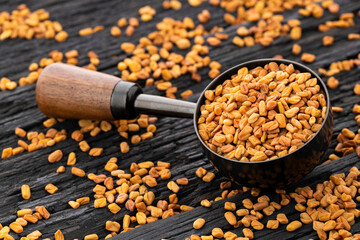 Natural aromatic fenugreek seeds in the measuring spoon - Natural food