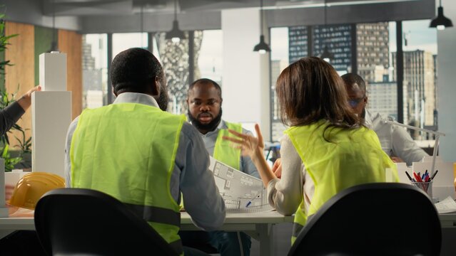 Group of diverse colleagues consulting on a master plan for urban development. Property developers reviewing architectural software to achieve real estate growth, innovation. - Powered by Adobe