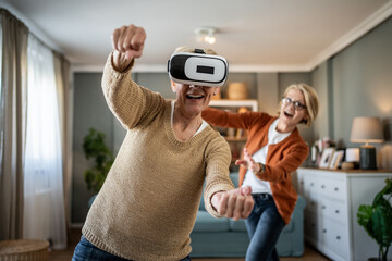 Seniors enjoying virtual reality gaming together at home