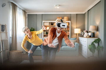 Senior women playing virtual reality game at home