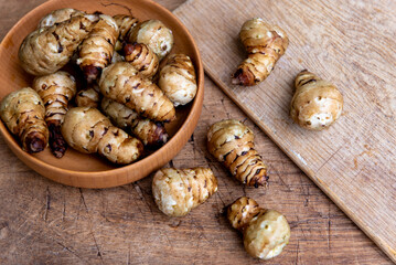 Fresh Sliced Jerusalem Artichokes on Wooden Cutting Board