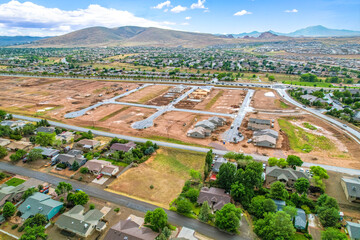Aerial view of a residential area with mountains behind