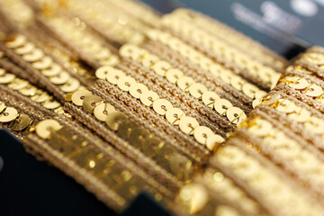 Gold sequin trim close-up with shiny decorative embellishments