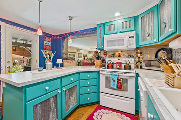 A vibrant kitchen interior showcasing beautiful teal cabinets