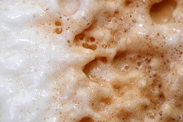 Top view of creamy milk coffee froth. Milk foamer is essential to most coffee beverages such as cappuccino, latte, mocha and macchiato