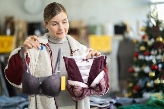 Girl at trading floor pick out and buying bra. Off line clothing store from retailer. Style and fashion look, modern trends. Designer clothing store, vintage fashion, limited edition