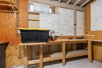 A black plastic box is currently resting atop a wooden workbench