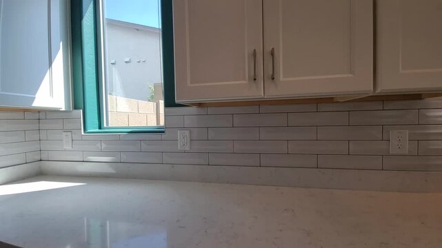 Detailed View Of Undercabinet Lighting And Textured Quartz Corner Surface With Soap Station 