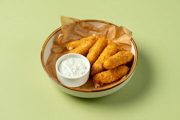 Golden fried treats sit in a rustic bowl, accompanied by a small dish of creamy dip. The warm, inviting colors create a pleasing culinary experience perfect for sharing