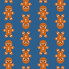 Bezszwowy wzór z piernikowymi ludzikami na niebieskim tle - świąteczna ilustracja wektorowa.