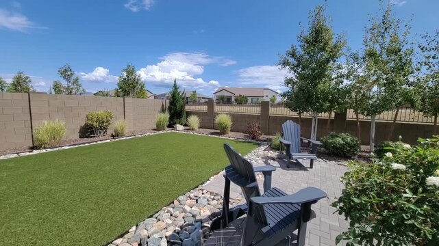 Peaceful Suburban Garden With Stones, Intimate Backyard Area With Lush Greenery And Comfortable Seating