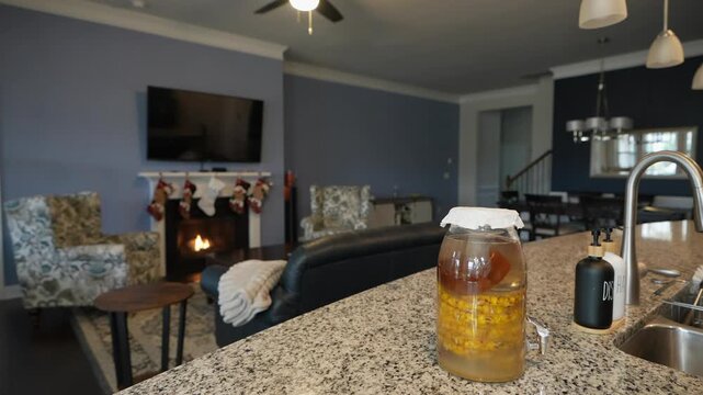 covering home brew tepache jar with cloth and rubber band